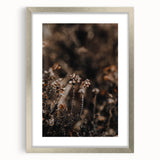 Textured abstract art print in warm autumn hues on a silver-framed canvas, ideal for bedroom wall decor.