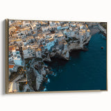 Framed canvas artwork depicting a stunning landscape of rugged cliffs under a vibrant sunset, featuring a gold frame that enhances its elegance. Perfect for home decor.