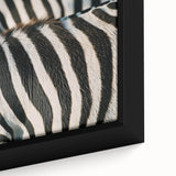 Close-up of a black-textured canvas featuring a colorful, abstract animal design.