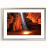Framed landscape artwork depicting vibrant canyons in rich earth tones, featuring a sleek silver frame and a white mat, perfect for enhancing any home decor.