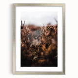 Textured abstract art print depicting fall colors in orange and brown on a silver-framed canvas, suitable for bedroom decor.