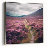 Framed canvas wall art depicting a serene countryside landscape with rolling hills and vibrant greenery, showcasing a silver frame from a side view. Perfect for enhancing home decor.