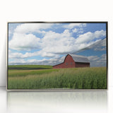 Framed acrylic artwork depicting a scenic landscape with a silver finish, featuring a rustic barn, ideal for home décor and enhancing interior aesthetics.