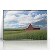 Framed acrylic landscape artwork showcasing a serene rural barn scene with vibrant colors, perfect for home decor or office aesthetics. The white frame enhances the visual appeal, adding elegance to any space.