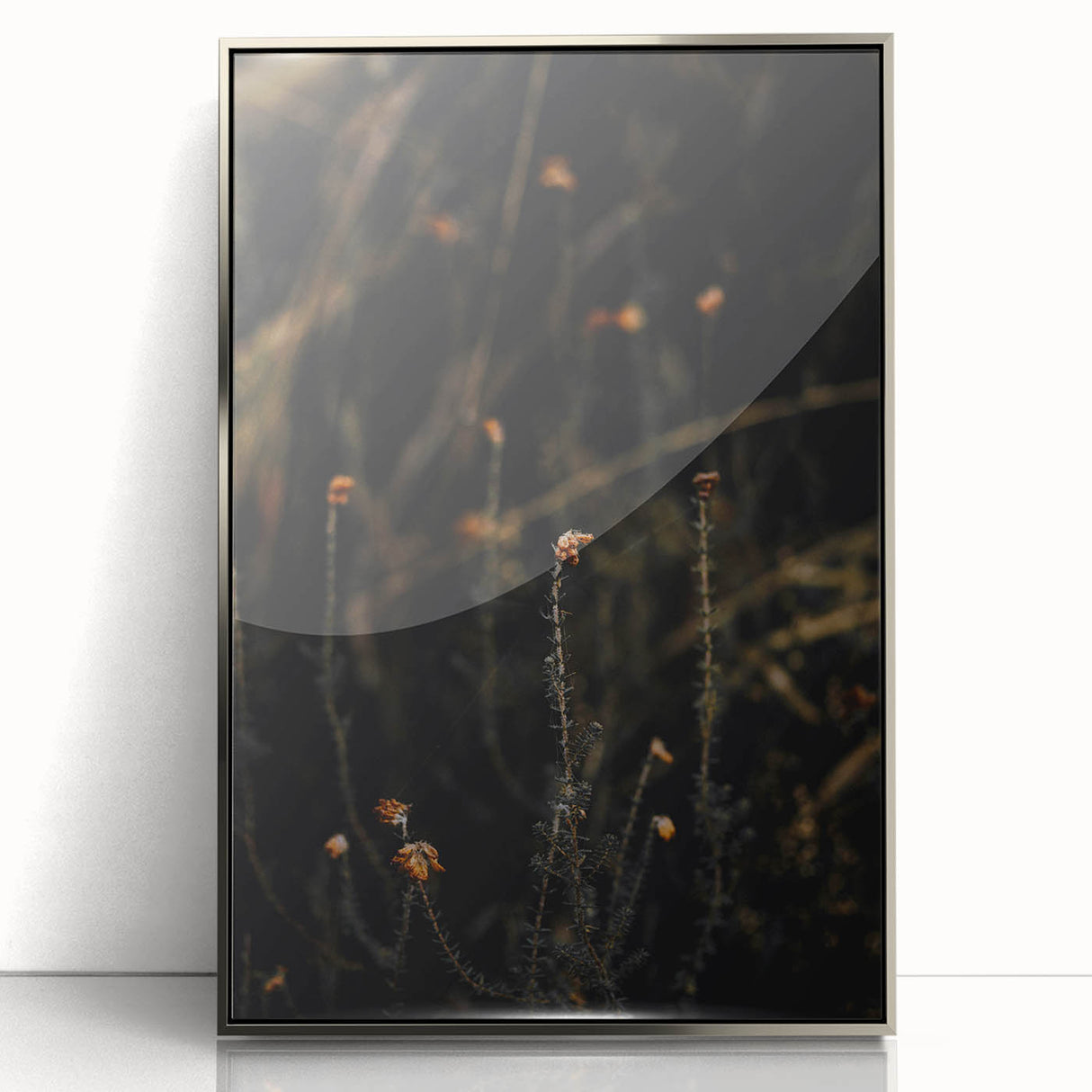 Mid-century modernist art depicting fall trees in vibrant orange and red hues, framed in silver acrylic.