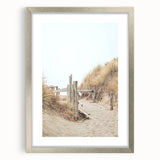 Textured abstract art print in vibrant orange and yellow tones, framed in silver, ideal for bedroom ambiance.