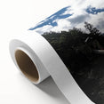Rolled canvas depicting a vibrant landscape bridge design, showcasing intricate details and rich colors, securely packaged in a protective cardboard tube for safe shipping.