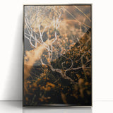 Mid-century modernist art depicting an autumnal forest in warm orange tones, framed in silver acrylic.