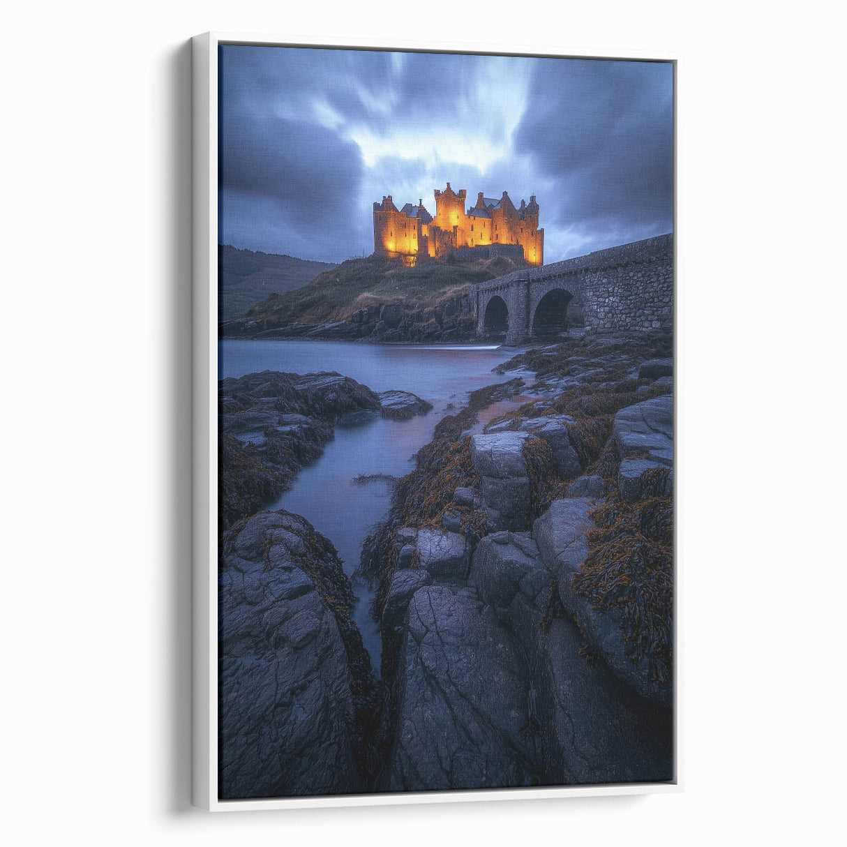 Framed canvas artwork depicting a serene countryside landscape with lush green fields and distant hills, showcased in a contemporary white frame.