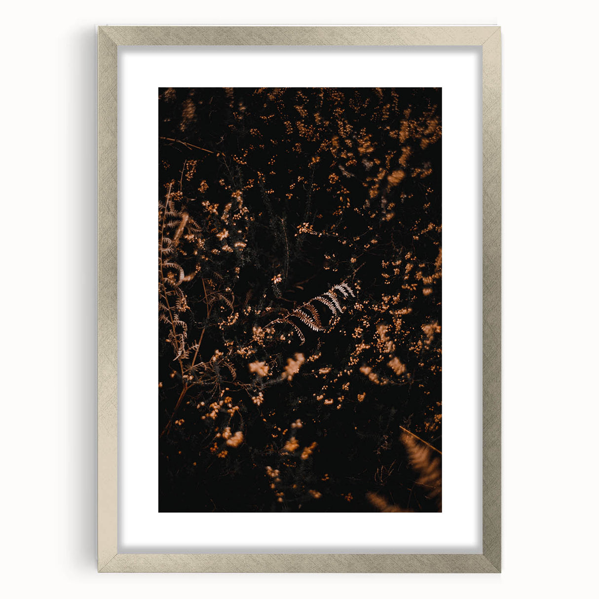 Textured abstract art print in autumnal shades on a silver-framed canvas, ideal for bedroom decor.
