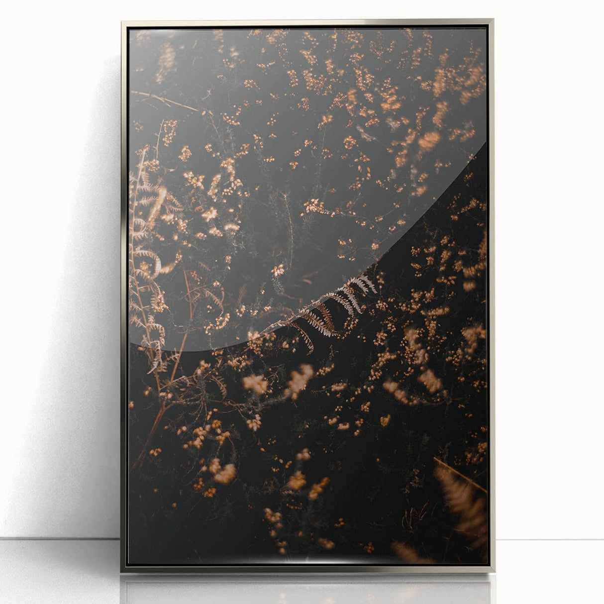 Mid-century modernist art depicting an abstract fall scene in orange and brown tones on a silver-framed acrylic print.
