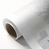 Winter scene with falling snow in muted blue tones on rolled canvas, ideal for nursery wall art.