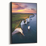 Framed canvas artwork depicting a dramatic cliff landscape in muted tones, showcasing intricate textures and a sleek black frame, perfect for modern home decor.