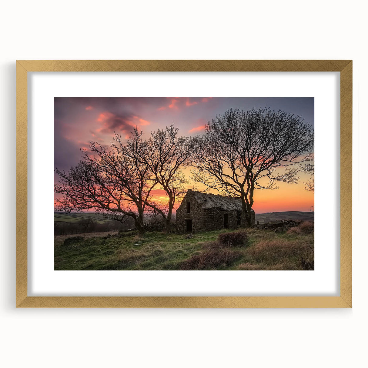 Elegant gold-framed landscape artwork featuring a barn scene, designed with a mat for added depth, perfect for home decor or rustic-themed interiors.