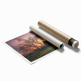 Rolled print of a serene landscape featuring a rustic barn surrounded by lush greenery, presented in a protective cardboard tube for safe transport and display.