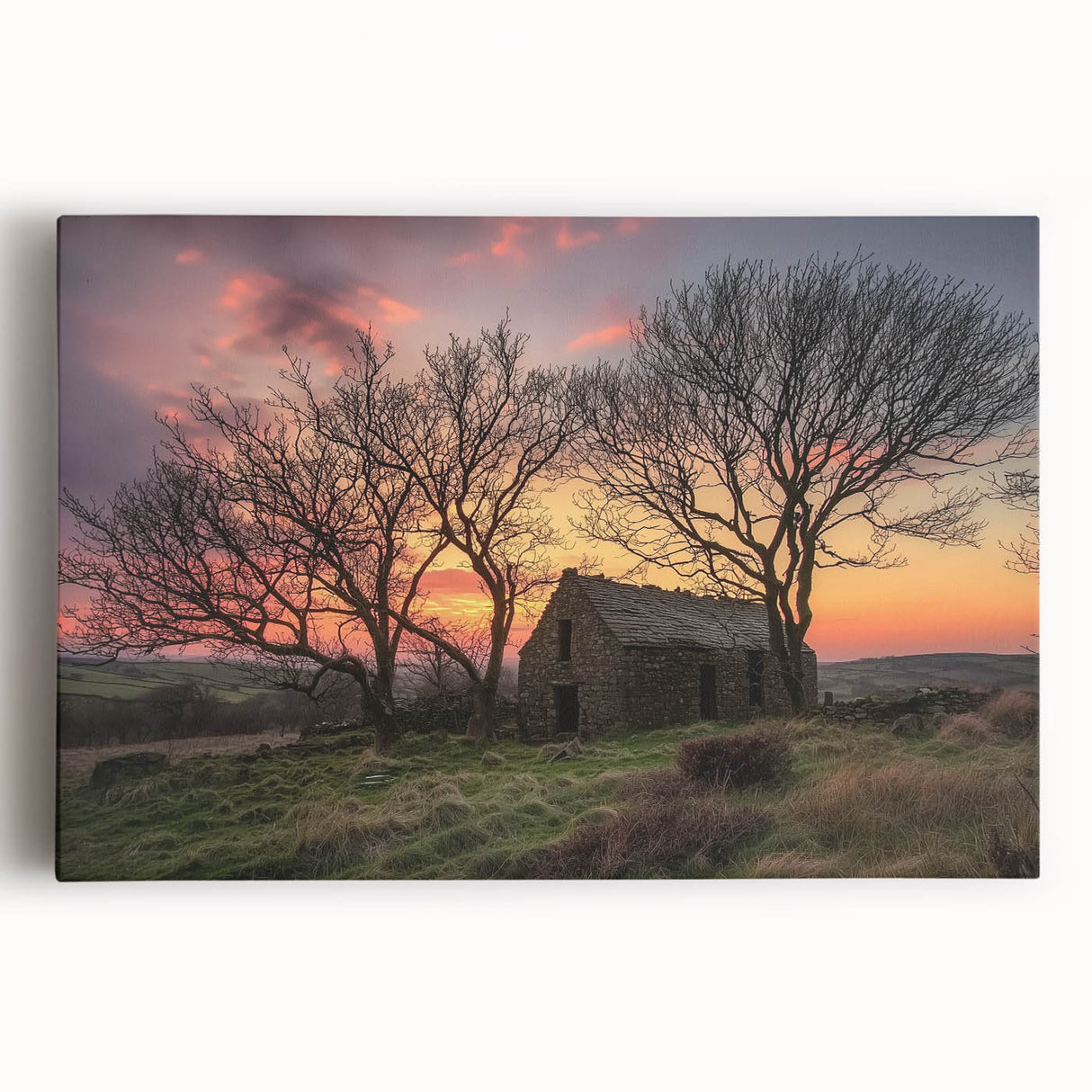 Stretched canvas artwork depicting a serene landscape scene with a rustic barn, showcasing vibrant greenery and a clear blue sky, perfect for home decor.