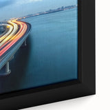 Close-up of a framed landscape canvas print showcasing a serene bridge scene over a tranquil river, with vibrant colors and detailed textures that enhance the visual appeal. Ideal for home decor, this artwork adds a touch of nature-inspired elegance to any space.