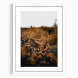 Abstract art print featuring autumnal hues in a white frame, ideal for dining room or bedroom decor.