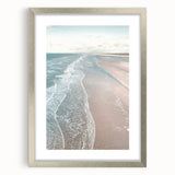 Textured abstract art print in muted blue and gray, framed in silver, ideal for modern bedroom ambiance.