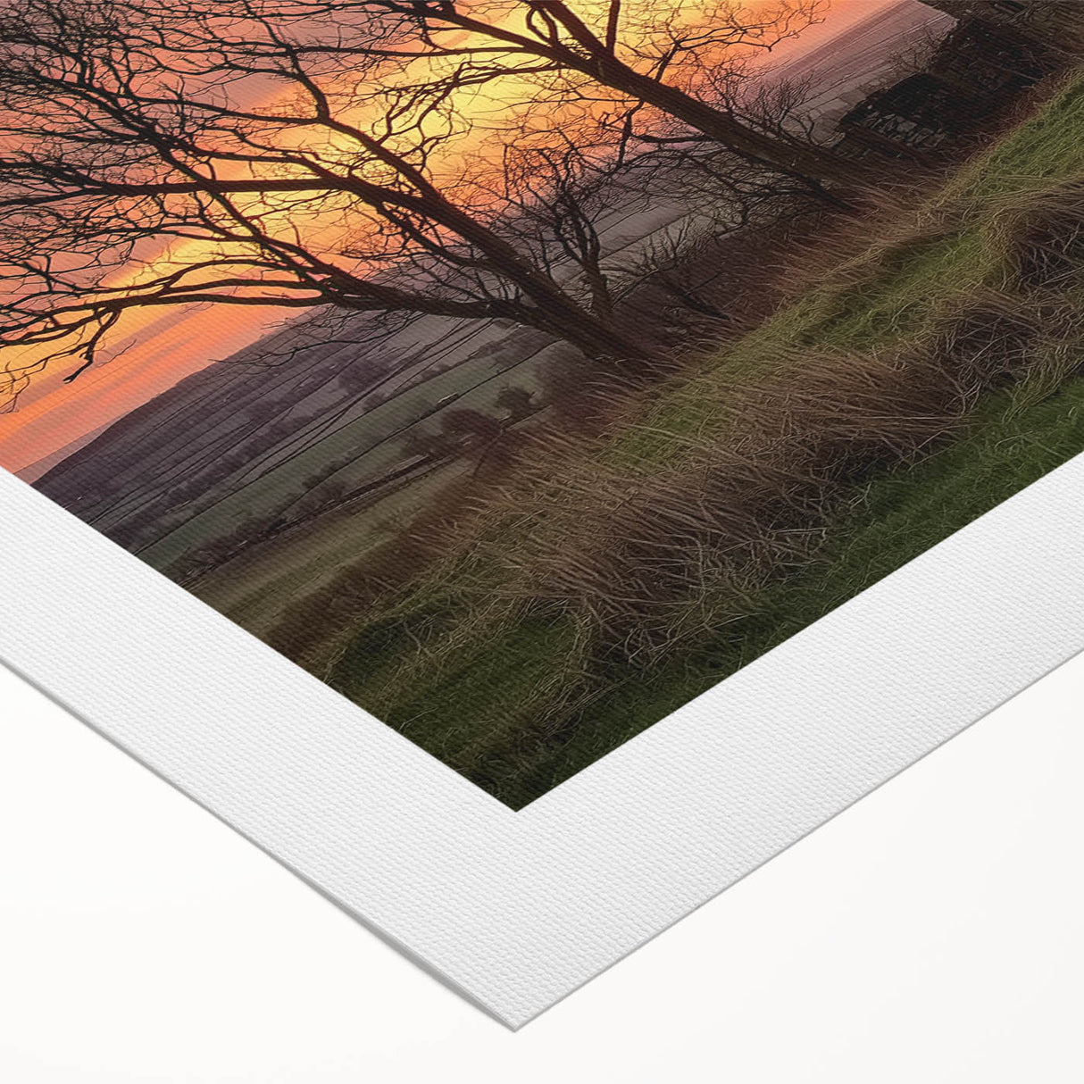Rolled canvas displaying a picturesque landscape of a rustic barn surrounded by vibrant fields, securely packaged in a durable cardboard tube for safe transport.