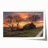 Landscape barn scene print showcasing a rustic red barn surrounded by lush green fields and a bright blue sky, rolled and ready for display in a cardboard tube.