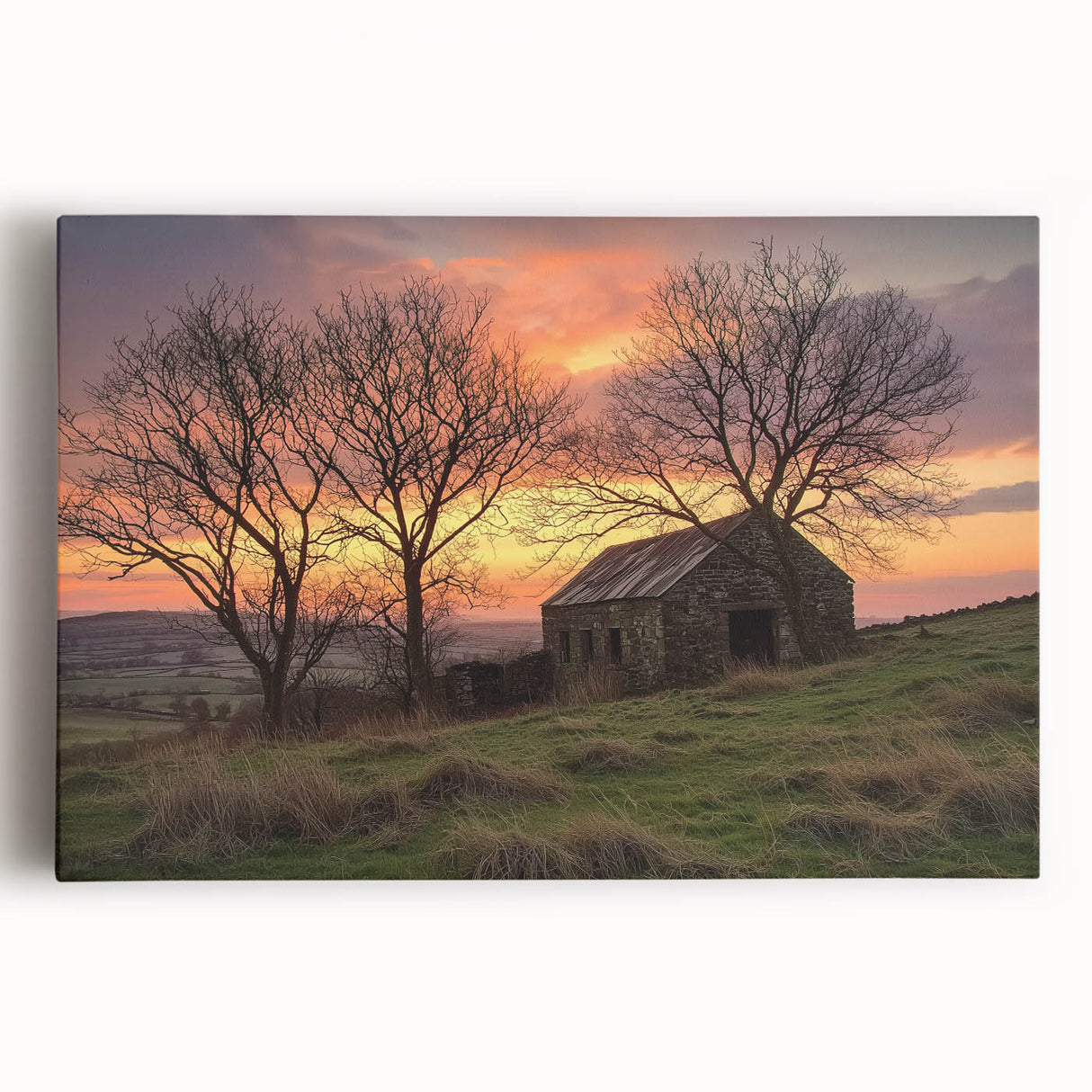Stretched canvas artwork depicting a serene landscape with a rustic barn surrounded by lush greenery and vibrant blue skies, ideal for farmhouse decor.