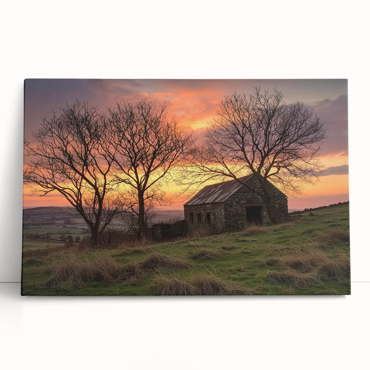 Landscape canvas print depicting a rustic barn surrounded by lush greenery and a vibrant sunset, ideal for home decor or farmhouse-themed interiors.