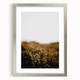 Textured abstract art print in warm autumnal tones on a framed silver canvas, ideal for bedroom ambiance.