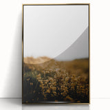 Acrylic print of fall trees in gold and orange tones, framed in gold, in a mid-century modernist style.