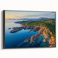 Framed canvas artwork depicting dramatic cliffs in a landscape setting, featuring deep blues and greens, with a sleek black frame enhancing its modern aesthetic. Perfect for adding a touch of nature-inspired elegance to home decor.