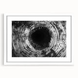 Abstract art print featuring close-up nature elements in muted green and brown tones, framed with a white mat.