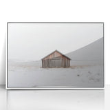 Framed acrylic artwork depicting a serene landscape scene with a white barn, set against a vibrant blue sky and lush green fields, ideal for rustic home decor.