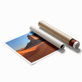 Desert landscape rolled print showcasing vibrant orange and gold hues, depicting a serene sunset over sand dunes, elegantly packaged in a protective tube for shipping.