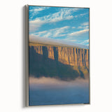 Framed canvas artwork showcasing a striking landscape of cliffs, featuring silver accents on the frame that enhance the natural beauty of the scene. Perfect for adding a modern touch to home decor.