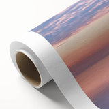 Rolled canvas artwork showcasing a vibrant landscape bridge design, featuring rich colors and intricate details, elegantly packaged in a protective cardboard tube for safe shipping and display.