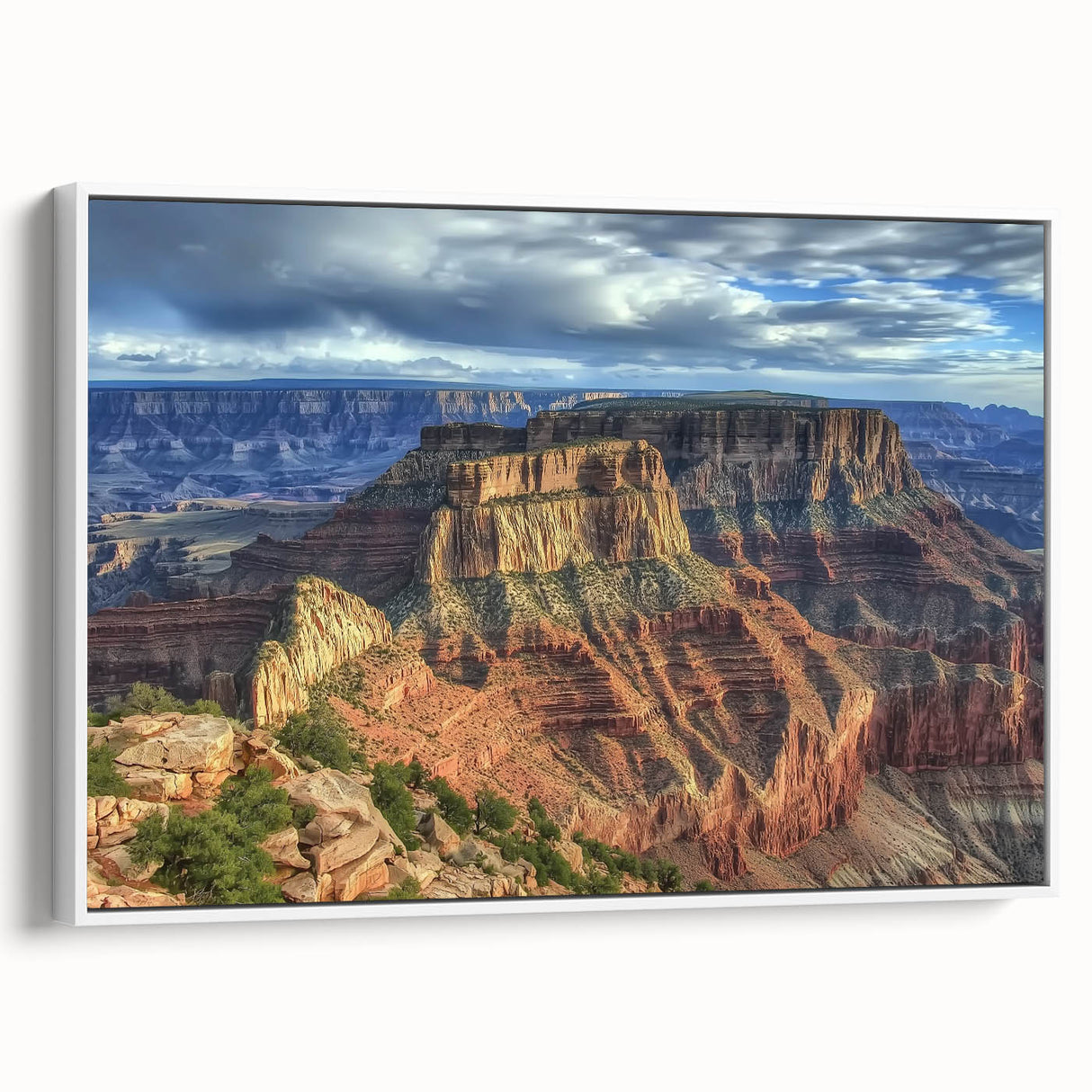 Framed canvas artwork depicting a vibrant landscape of canyons in rich earth tones, showcased from a side view against a white background, ideal for home decor.