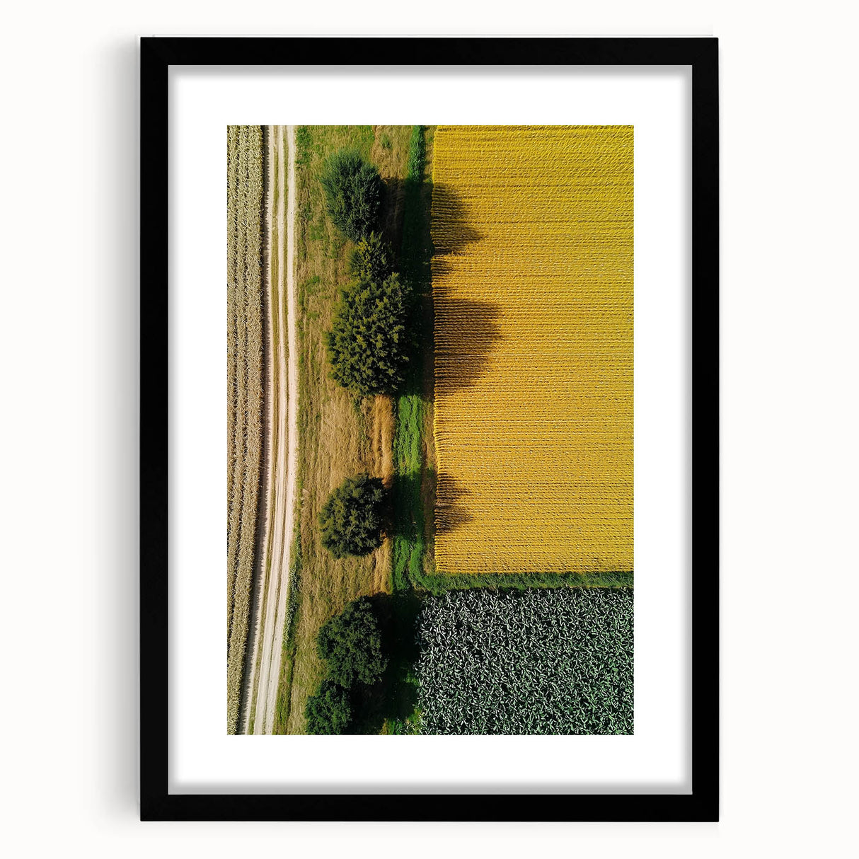 Black-framed landscape artwork featuring a serene countryside scene with vibrant greens and a clear blue sky, perfect for home decor or office spaces.