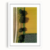Framed landscape artwork in a white mat, showcasing a serene countryside scene with rolling hills and a clear blue sky, perfect for home decor.