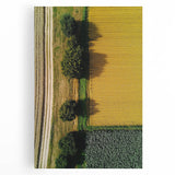 Stretched canvas artwork depicting a serene countryside landscape with rolling hills and a vibrant blue sky, ideal for home decor or art enthusiasts.