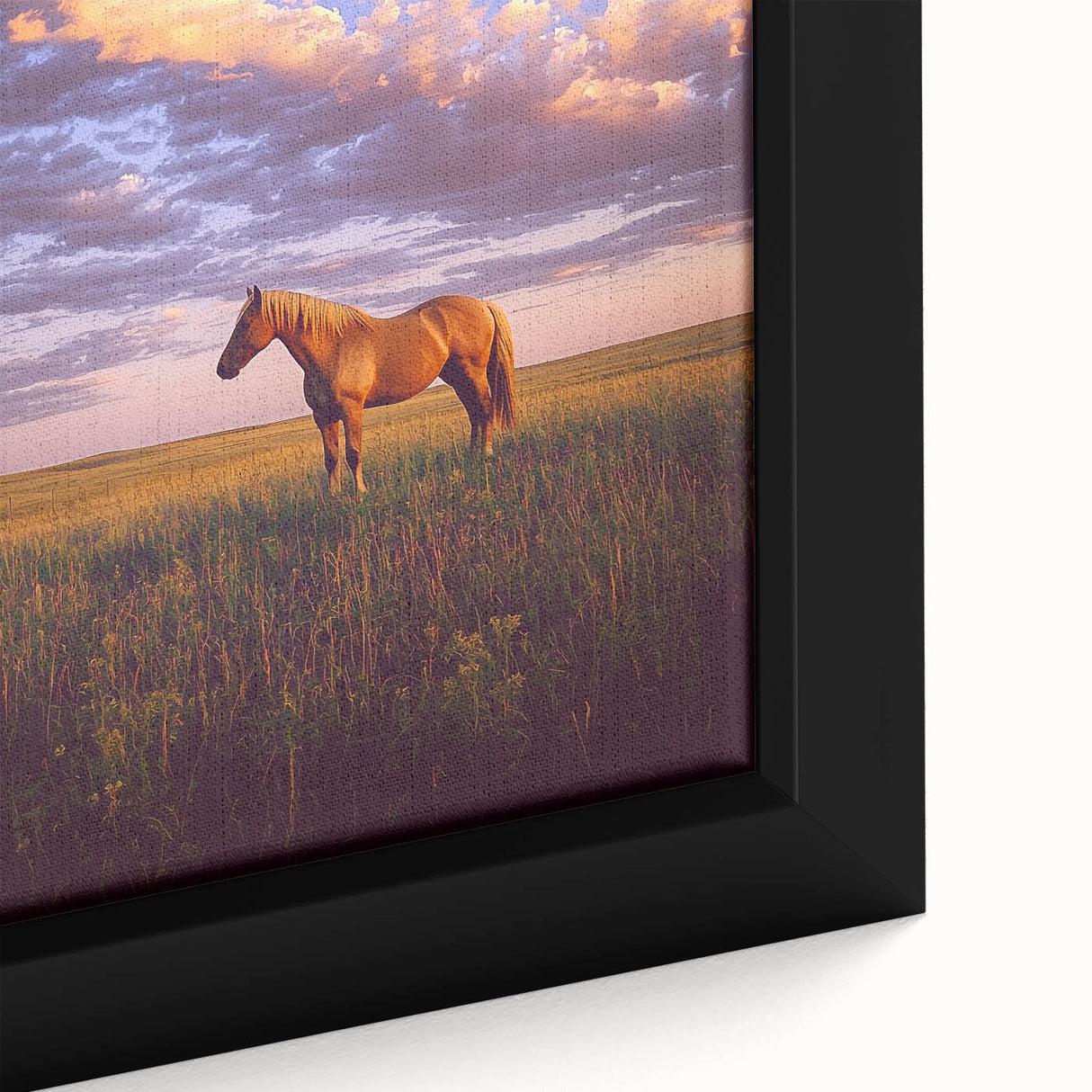 Close-up of a framed canvas artwork depicting a serene countryside landscape, featuring lush green hills, a clear blue sky, and vibrant wildflowers, enhancing home decor.