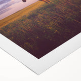 Vibrant rolled canvas artwork depicting a serene countryside landscape, showcasing lush green fields and a clear blue sky, perfect for home decor.