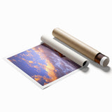 Rolled print showcasing a serene countryside landscape with rolling hills and a vibrant sky, packaged in a protective cardboard tube for safe transport. Perfect for home decor enthusiasts seeking nature-inspired artwork.