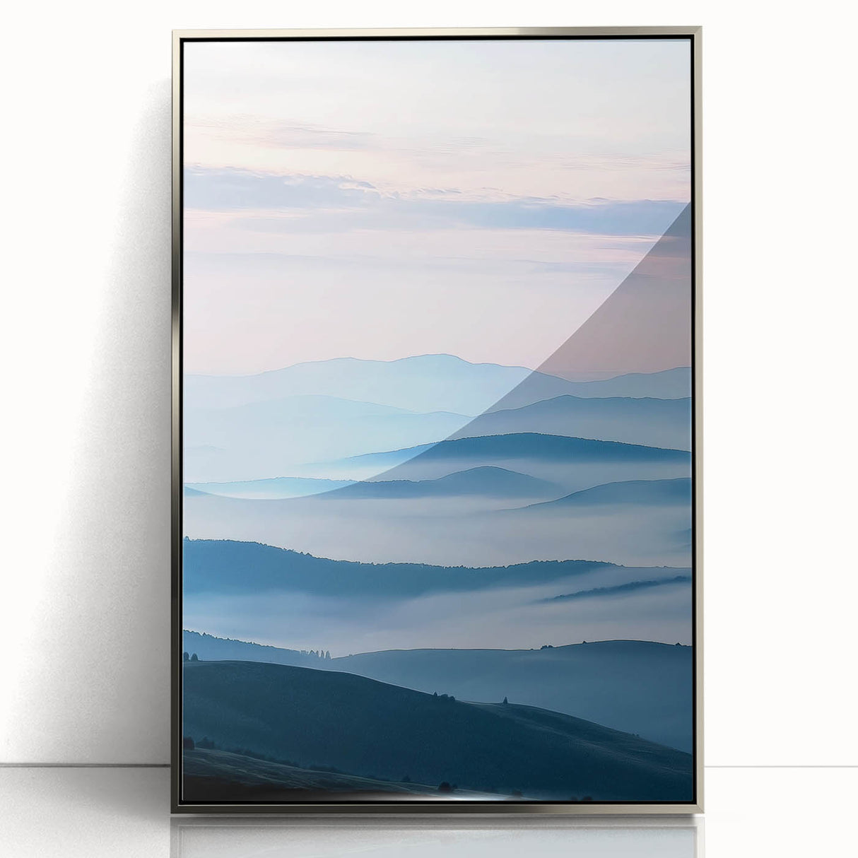 Framed acrylic landscape artwork showcasing a serene countryside scene with vibrant green fields and a clear blue sky, presented in a sleek silver frame.