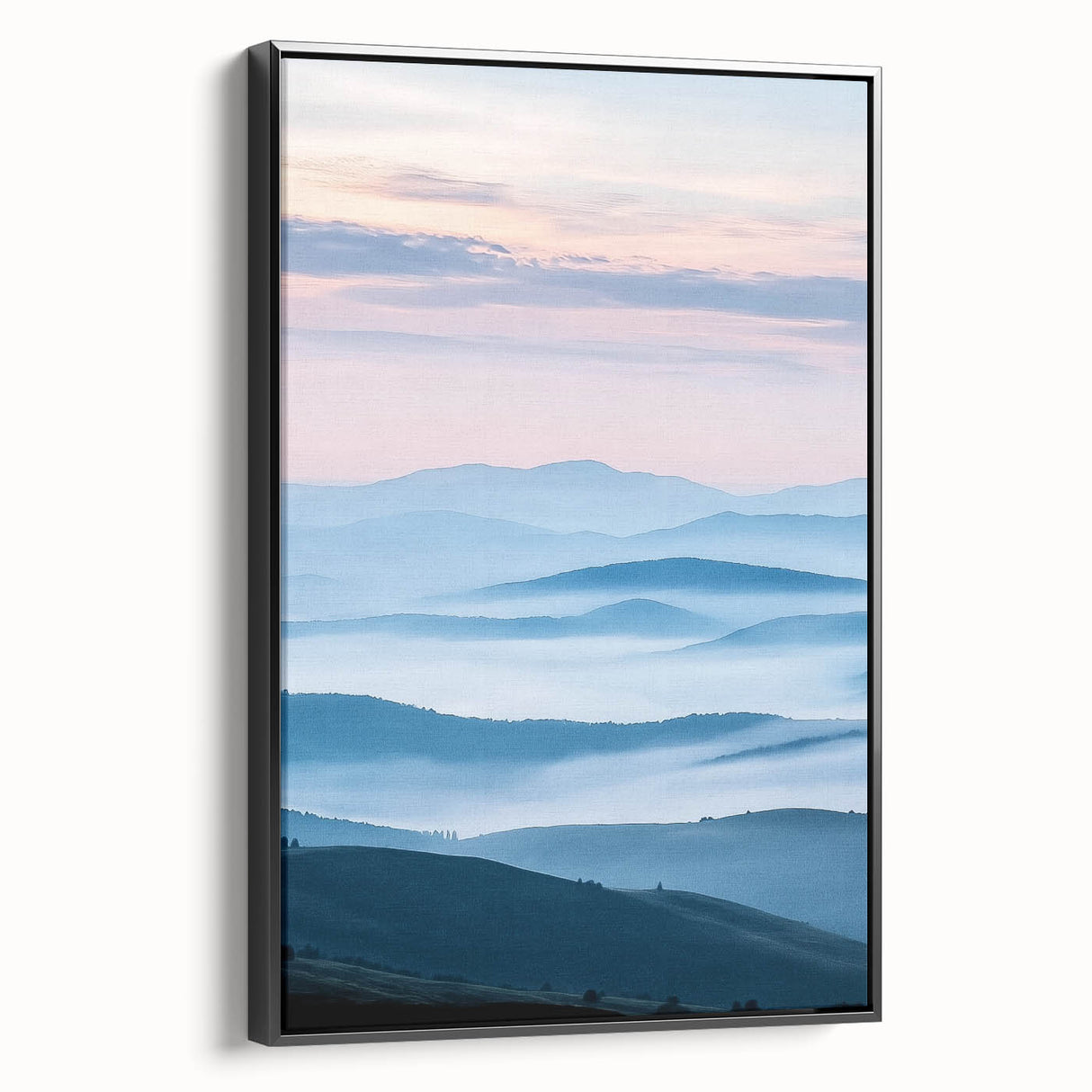 Framed canvas artwork of a serene countryside landscape, showcasing lush green fields and a clear blue sky, with a sleek black frame enhancing its elegance.