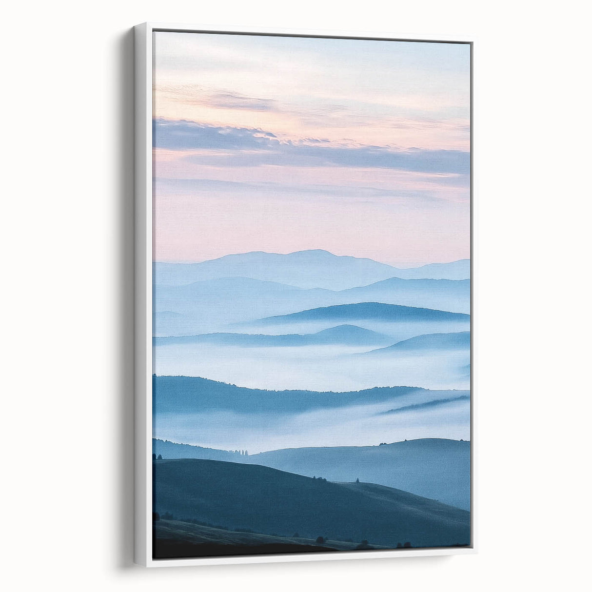 Framed canvas artwork depicting a serene countryside landscape with vibrant green fields and a clear blue sky, showcased from a side view against a white background.