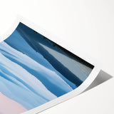 Rolling hills of a picturesque countryside landscape print featuring lush green fields and a serene blue sky, elegantly rolled for easy transport and display.
