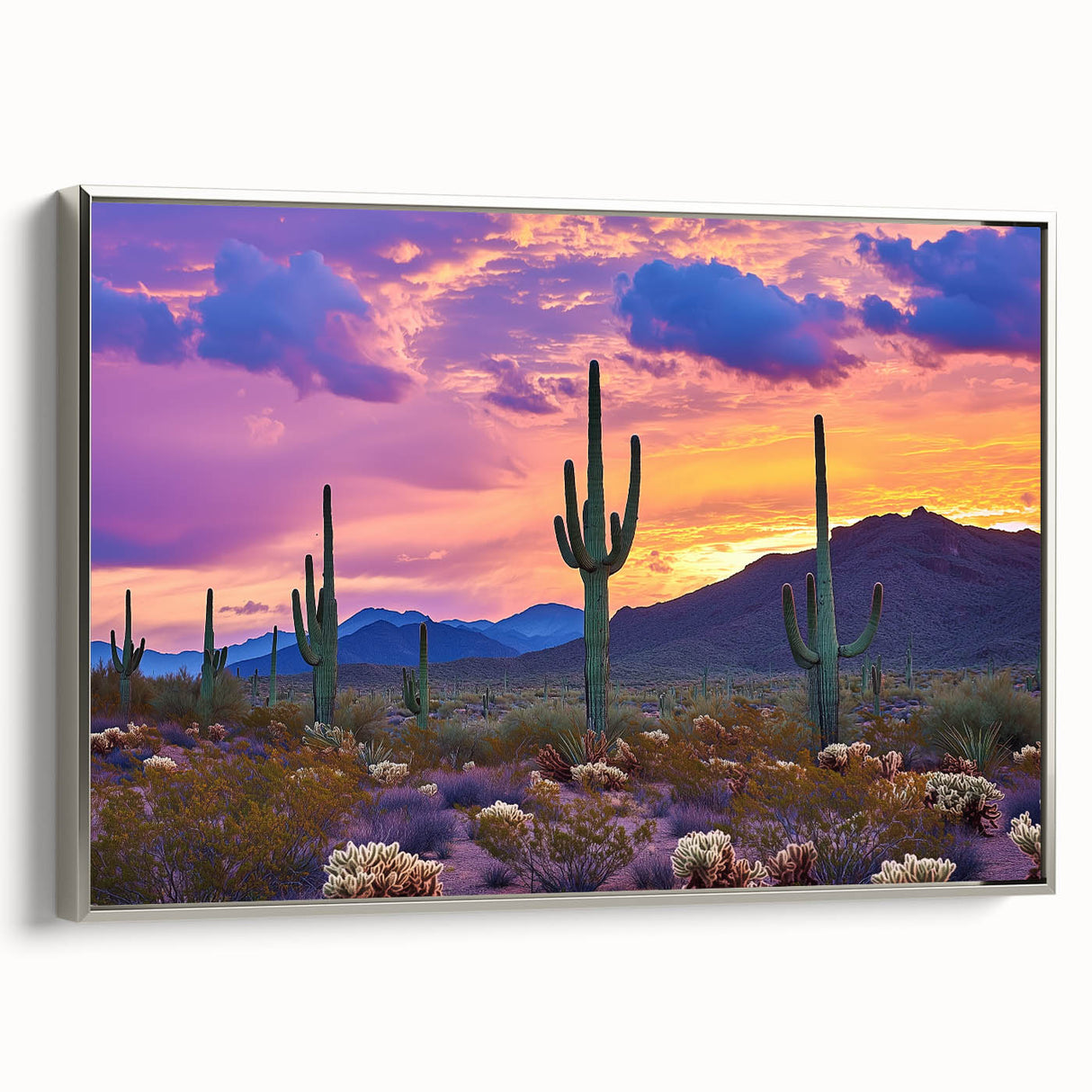 Framed canvas artwork showcasing a vibrant desert landscape with rich colors, elegantly displayed from a side view, featuring a sleek silver frame for a modern touch.