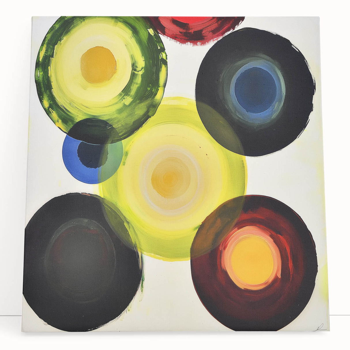 Abstract geometric canvas art featuring bold colors and sharp lines, leaning against a wall, perfect for modern home decor and artistic interior design.