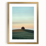 Elegant gold-framed landscape artwork depicting a serene countryside scene, featuring lush green fields and a vibrant sky, perfect for home decor enhancement.
