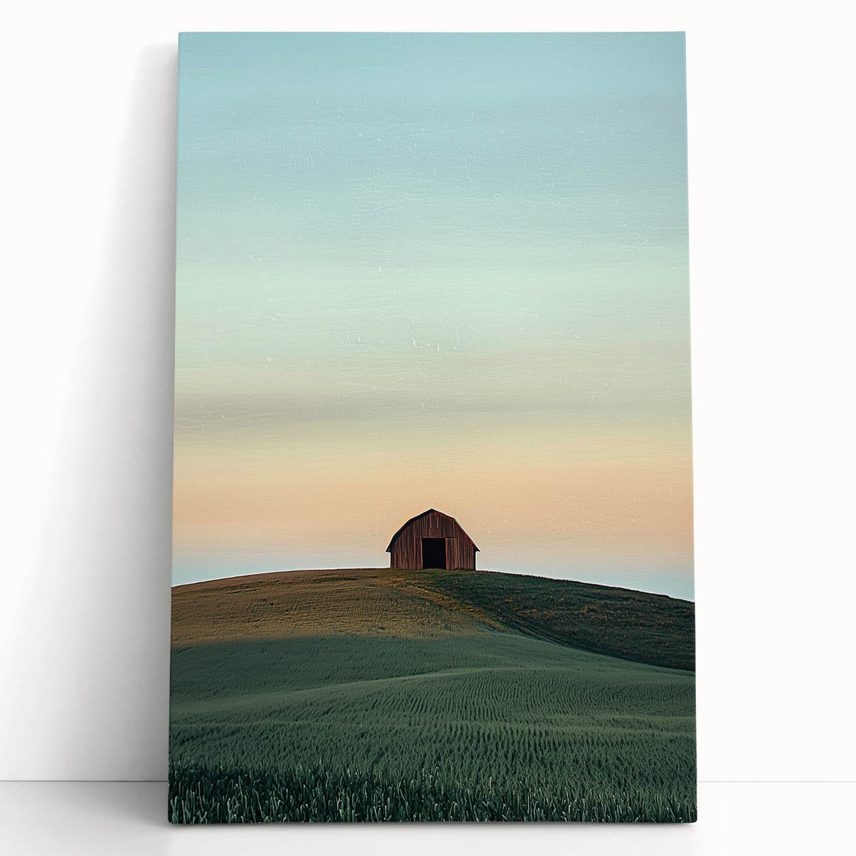 Stretched canvas artwork depicting a serene countryside landscape with rolling hills and a clear blue sky, leaning against a rustic wooden backdrop, ideal for home decor.